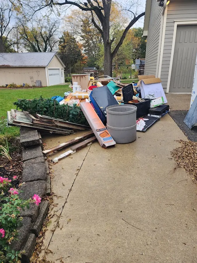 Dumpster being loaded with debris for Roofing Dumpster Rental in Chittenango